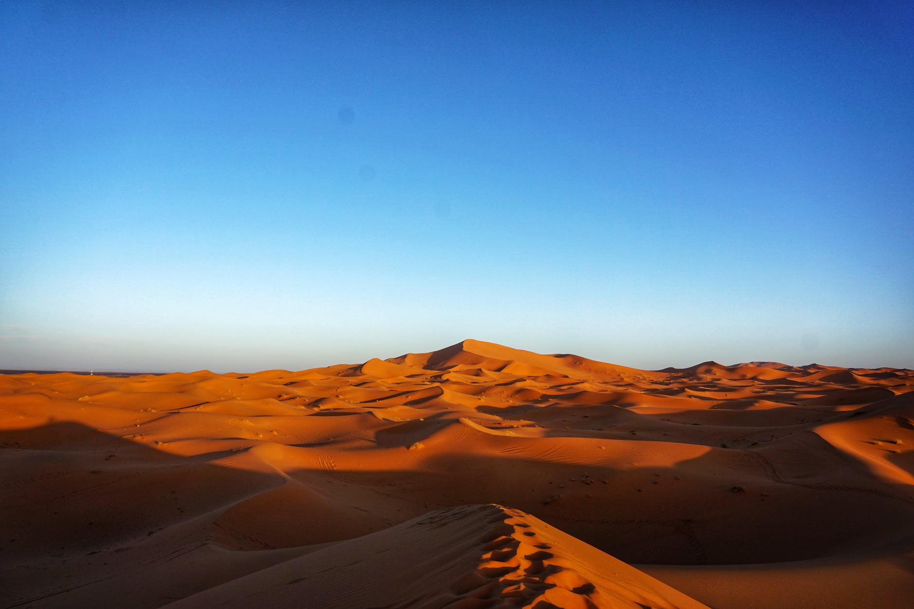 brown sand under blue sky