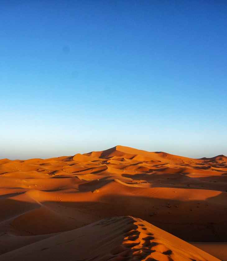 brown sand under blue sky