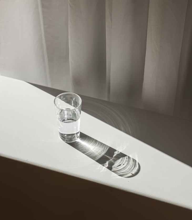 a glass of water on white table