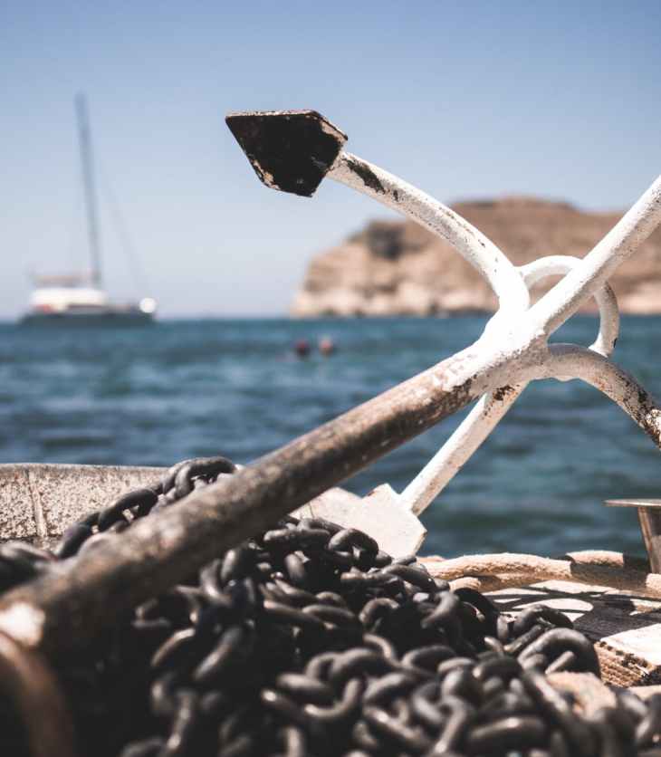 white and black anchor with chain at daytime
